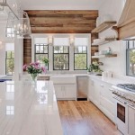 Lovely farmhouse kitchens - this one with the barn wood wall is my favorite!