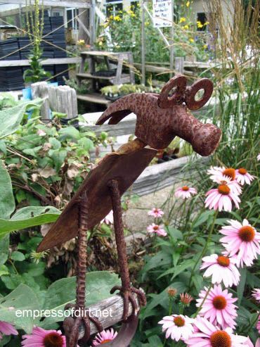 Garden art made from repurposed farm equipment. Tons of great ideas in this post!